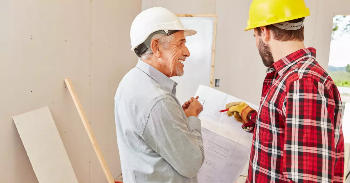 A person wearing hardhat and a white helmet looking at a person wearing a helmet