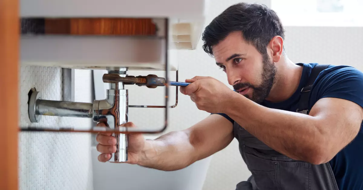 A person fixing a sink